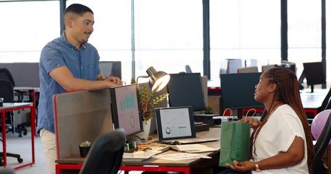 Colleagues holding discussion with office decor and charts