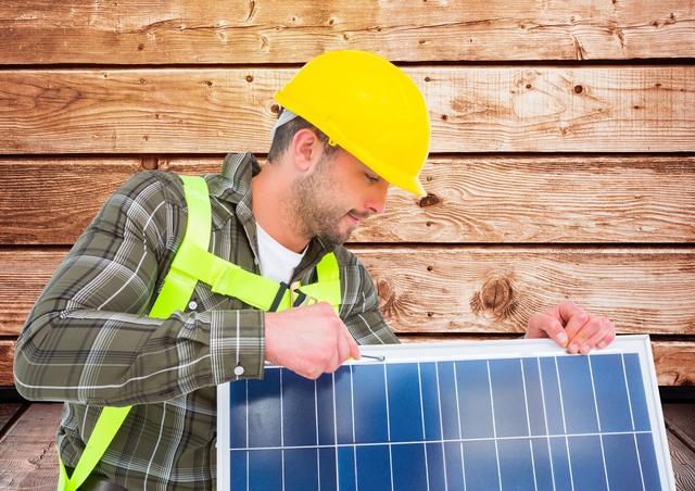 Digital composite image of worker fixing solar panel against wooden background