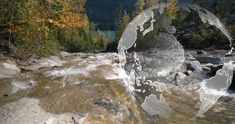 Flowing mountain stream with transparent globe overlay in autumn alpine valley