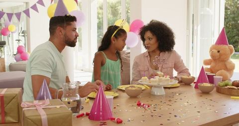 Family Enjoys Birthday Celebration with Cake and Decorations