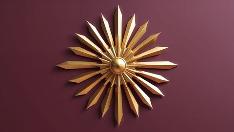 Golden sunburst sculpture on burgundy wall