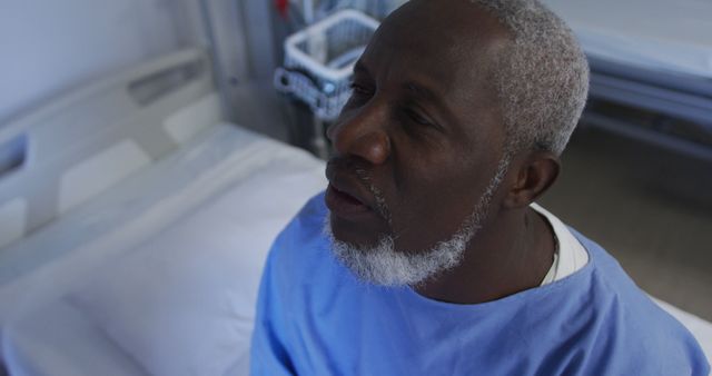 Senior Male Patient in Hospital Gown Sitting on Hospital Bed - Download Free Stock Images Pikwizard.com