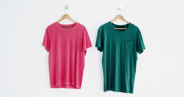 Red and Green T-Shirts Hanging on Wooden Hangers Against White Background - Download Free Stock Images Pikwizard.com