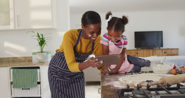 Mother and Daughter Baking in Kitchen Watching Recipe on Tablet - Download Free Stock Images Pikwizard.com