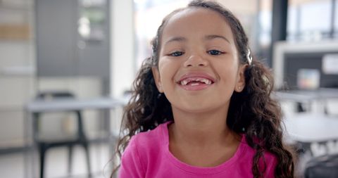 Smiling Young Girl with Missing Teeth in Classroom Environment - Download Free Stock Images Pikwizard.com