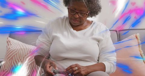 Senior woman using smartphone with vibrant digital effects