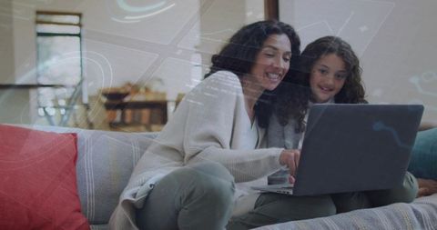 Mother and Daughter Learning Together on Laptop on Cozy Sofa Sharing Digital Moment