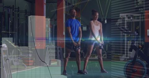 Partner kettlebell training on gym turf for strength and functional conditioning