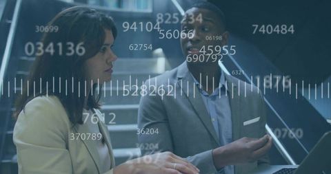 Business professionals discussing data analytics with HUD metrics overlay and laptop