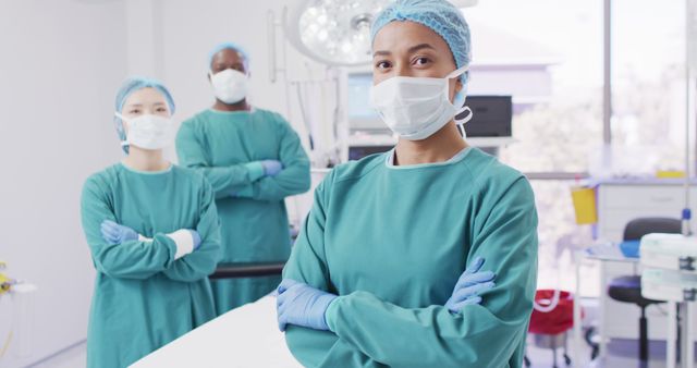Image of three diverse surgeons dressed for operation in operating theatre. Hospital, medical and healthcare services.