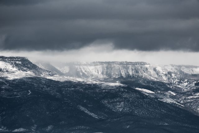 Mountainous Winter Landscape Under Dark Cloudy Sky - Download Free Stock Photos Pikwizard.com