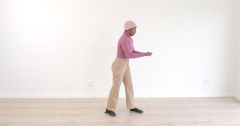 Woman in minimalist space practicing contemporary dance moves