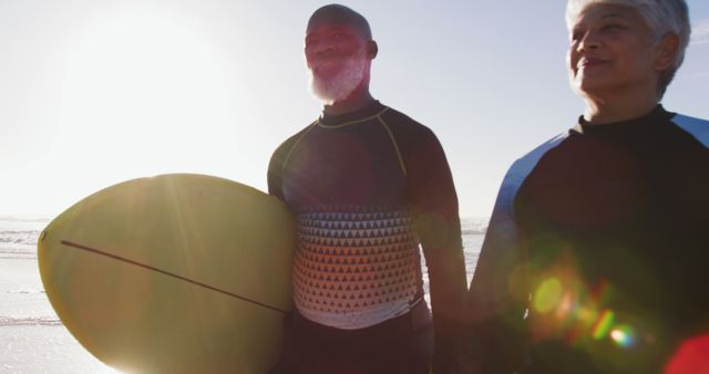 Senior Couple Holding Hands at Beach with Surfboard at Sunset - Download Free Stock Images Pikwizard.com