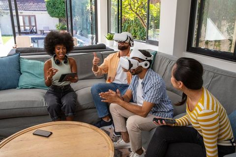 Diverse Friends Engaging in Virtual Reality Experience in Modern Living Room