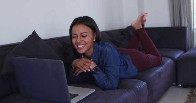 Happy Young Woman Watching Content on Laptop at Home - Download Free Stock Images Pikwizard.com