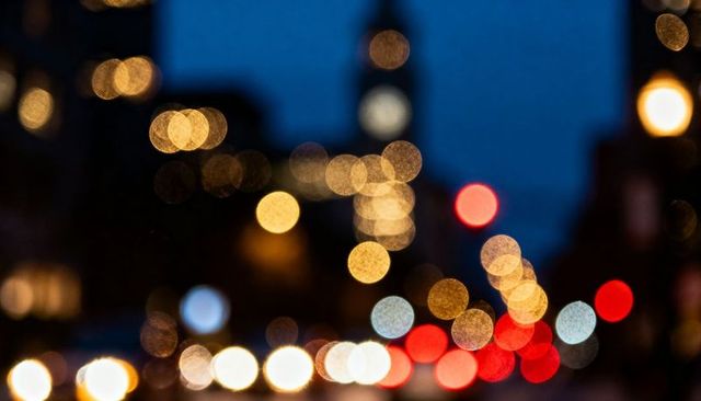 Glowing Bokeh Street Lights at Dusk Creating Urban Night Traffic Mood Neon Cityscape