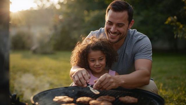 Father and daughter bonding while grilling burgers outdoors