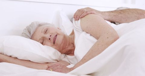 Peaceful Senior Woman Sleeping Quietly in Cozy Bed