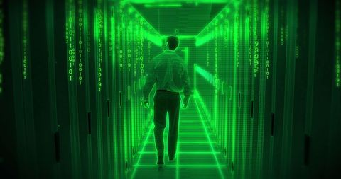 Businessman Walking Through Neon Green Data Server Room - Download Free Stock Images Pikwizard.com