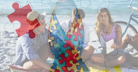 Autism awareness symbol overlapping beach gathering with friends