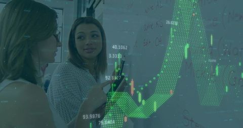 Female Colleagues Analyzing Financial Chart on Whiteboard