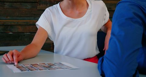 Business Professionals Analyzing Photographs in Modern Office