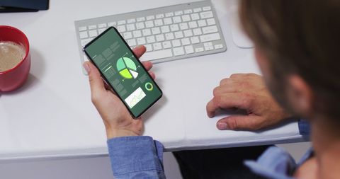 Man Analyzing Data on Smartphone at Office Desk - Download Free Stock Images Pikwizard.com