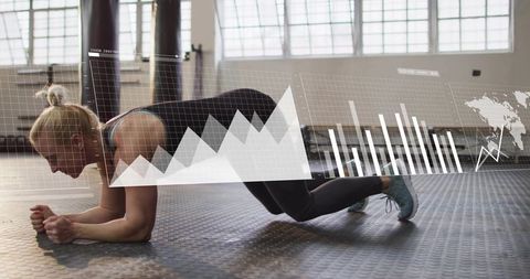 Female athlete holding forearm plank with fitness analytics overlay in bright gym studio