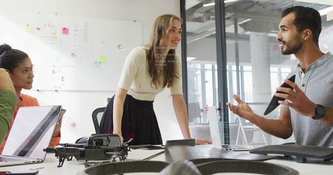 Diverse Team Collaborating in Modern Office with Drone