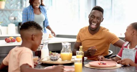 Joyful Family Lunch with Smiling Father and Children