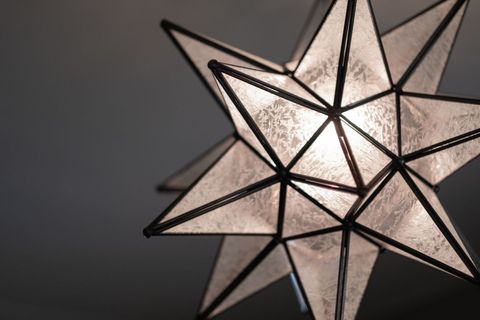 Modern Star-Shaped Geometric Lamp Lighting Up Room Interior
