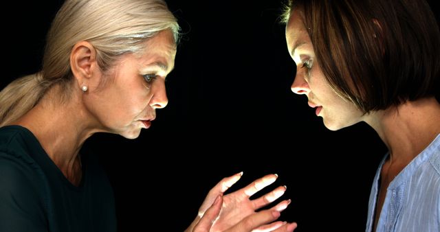 Serious Discussion Between Two Women in Low Light Setting - Download Free Stock Images Pikwizard.com