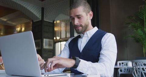 Caucasian Businessman Working on Laptop in Cafe