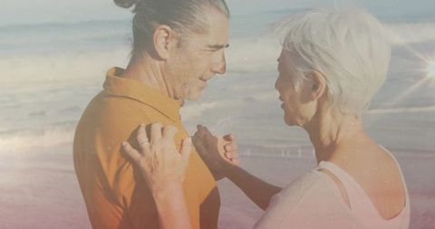 Couple Embracing at Sunset Beach with Ocean in Background