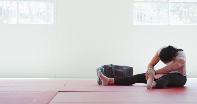 Woman Stretching on Yoga Mat in Bright Indoor Studio - Download Free Stock Images Pikwizard.com