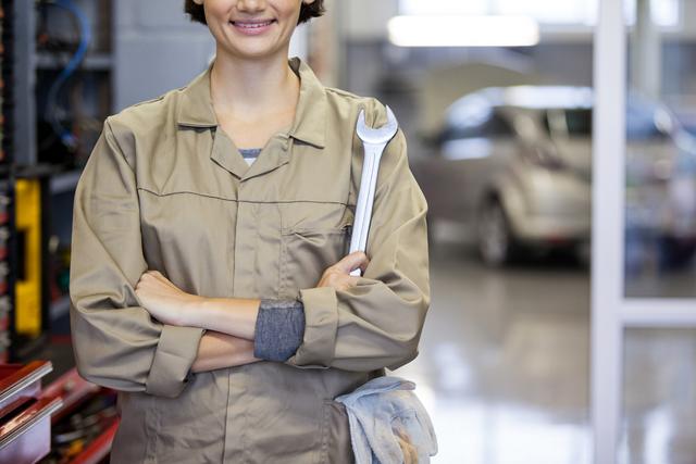Female Mechanic Holding Spanner in Auto Repair Garage - Download Free Stock Photos Pikwizard.com