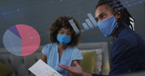 Biracial businessman analyzing data visualization with colleague