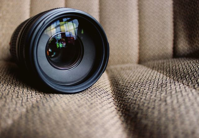 Black Camera Lens on Brown Textile - Download Free Stock Photos Pikwizard.com
