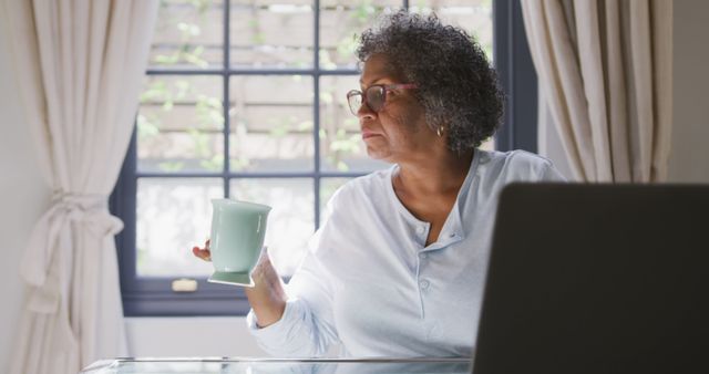 Senior African American Woman Enjoying Coffee While Working From Home - Download Free Stock Images Pikwizard.com
