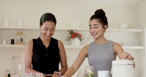 Friends Creating Healthy Smoothies in Modern Kitchen