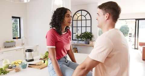 Diverse Couple Creating Fresh Smoothie Together in Bright Kitchen