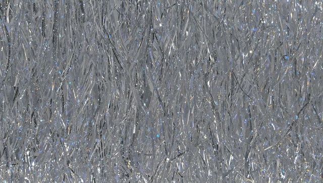 Shimmering silver tinsel fringe background with iridescent blue and purple glints