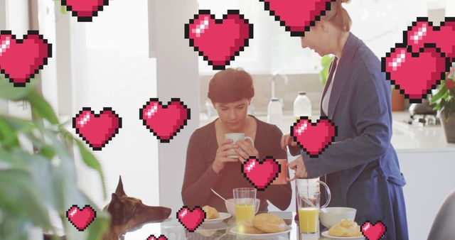 Image of heart emojis over happy caucasian female couple with dog. Love, romance and celebration concept digitally generated image.