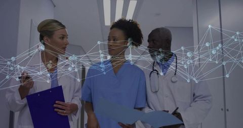 Medical team discussing patient files with technology overlay