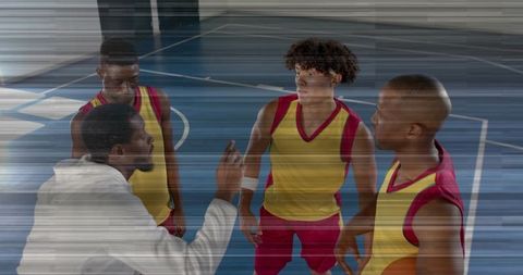 Basketball Coach Guides Players on Court Strategy and Motivation