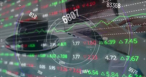 Analyzing Stock Market Trends with Laptop and Coffee in Office