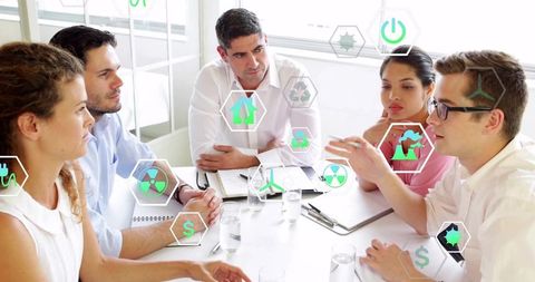 Business team discussing sustainable energy strategy with augmented reality icons
