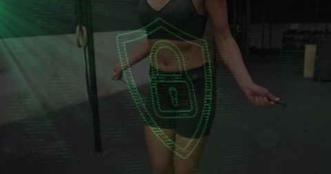 Female athlete skipping rope while holding jump rope with green digital shield overlay