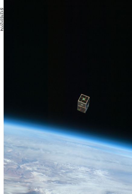 Image showcases the release of the DRAGONSat, a satellite designed by students at the University of Texas and Texas A&M, from Space Shuttle Endeavour. The satellite floats against the backdrop of Earth's blue and white horizon and the blackness of space. Useful for articles and content about space exploration, satellite technology, educational projects in aerospace engineering, and GPS-based navigation systems in space.