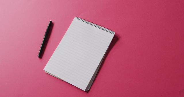 Image of pen and notebook with copy space on pink background. communication and tradition concept.